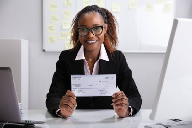 close up of a smiling businesswoman showing company cheque