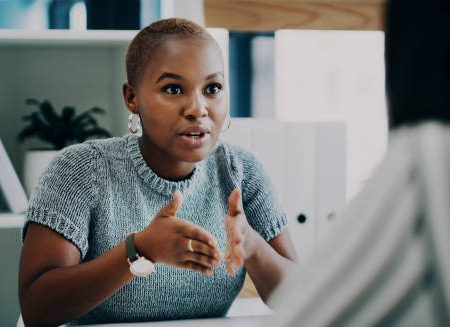 shot of a young businesswoman having a discussion with a colleague in an office