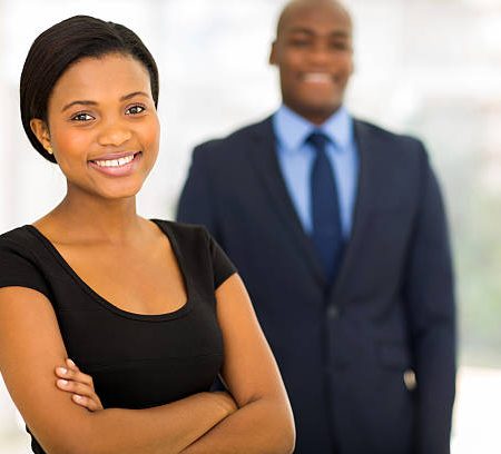 beautiful young african businesswoman standing in front of her colleague