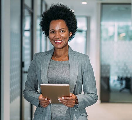 shot of beautiful smiling businesswoman holding digital tablet in the office.